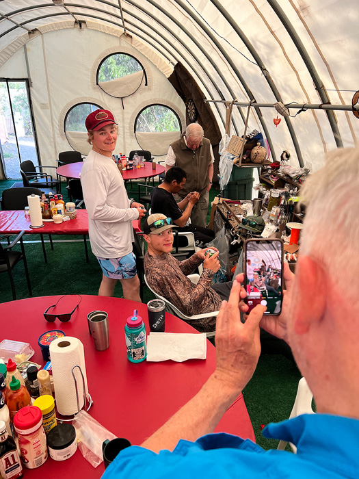 Guides tying flies inside the main tent