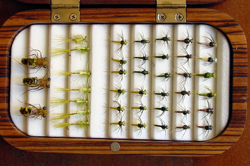 beautiful wooden fly box with assorted fishing flies