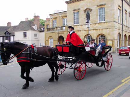 Peolpe riding in a horse draw carriage