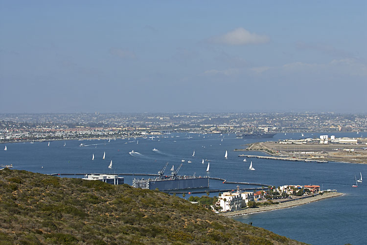 San Diego harbor view with a large Navy ship headed to port