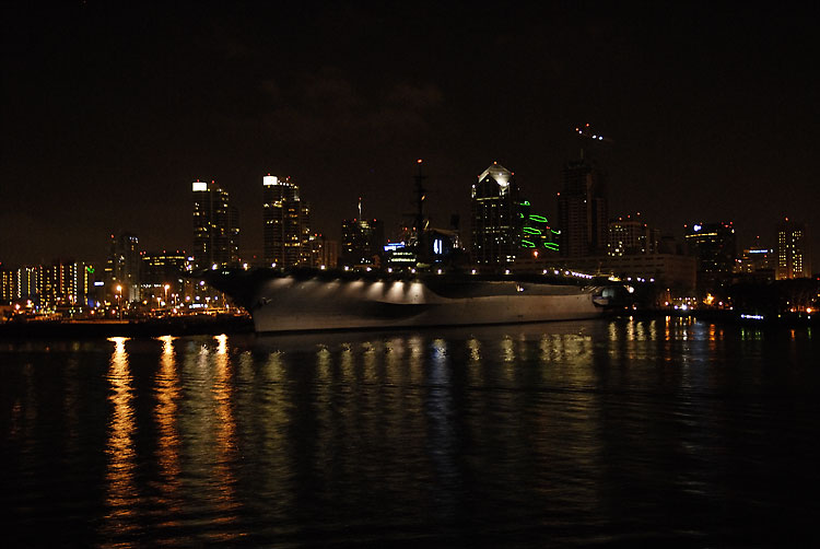 night snapshot of a large NAVY ship taken from the dinner crusie boat