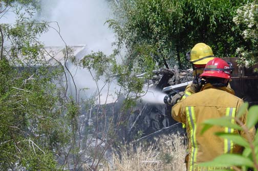 spraying water on a burning structure